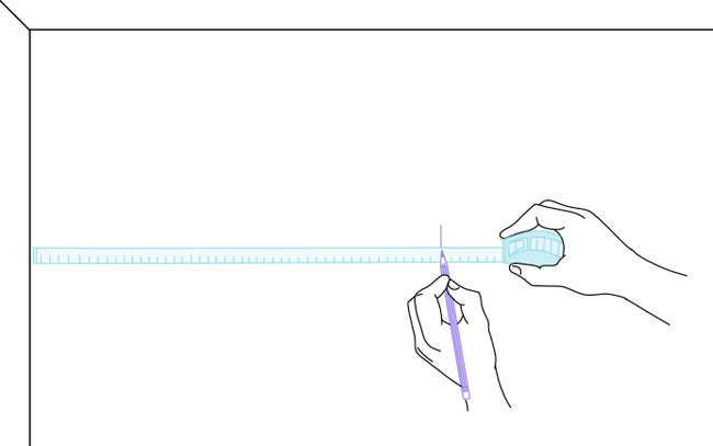 Dessin d'une main traçant un trait vertical au mur à l'aide d'un mètre