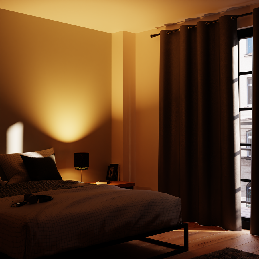 Chambre plongée dans l'obscurité par un rideau occultant installé à la fenêtre