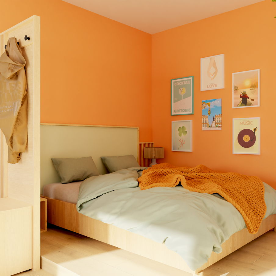 Coin lit avec six cadres illustrés sur mur orange