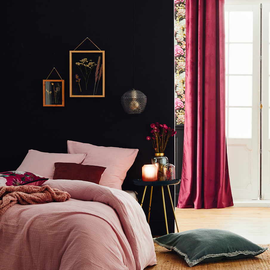 Chambre romantique motif fleuri, lit fait avec parure rose en gaze de coton