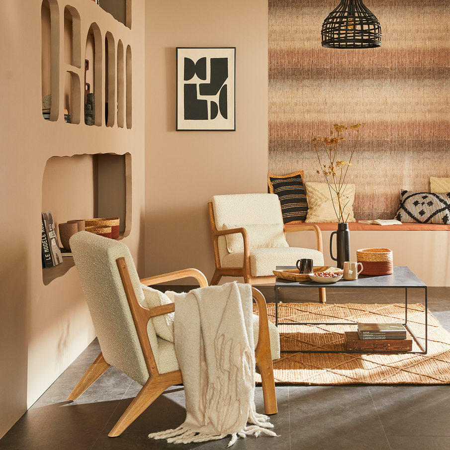 Salon aux murs couleur muscade, différentes alcôves sont creusées dans le mur, 2 fauteuils en bois et en laine bouclée