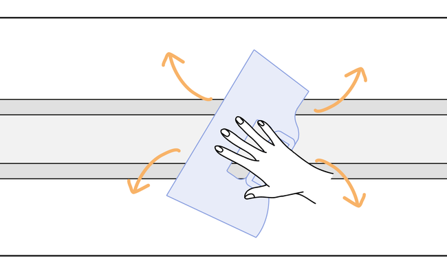Dessin d'une main posant une frise au mur à l'aide d'une spatule à maroufler