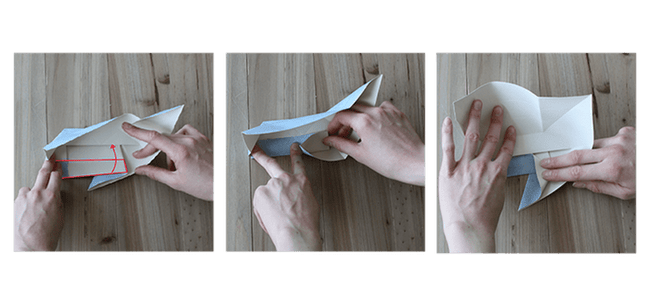 Etape 14 avec des mains qui effectuent des pliages vers l'intérieur du lapin