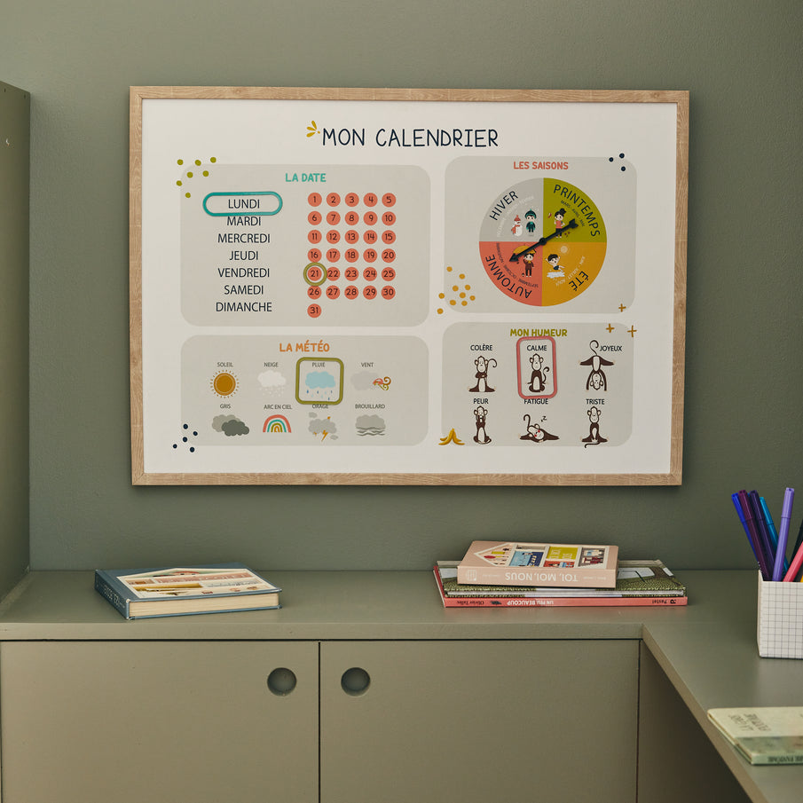 Tableau routines pour enfant accroché au mur vert kaki